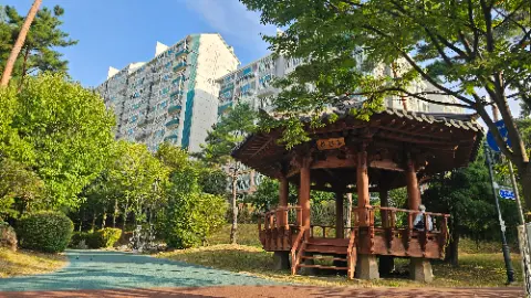 A wooden gazebo with a roof and a staircase