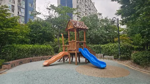 A wooden playground slide with a blue slide on top