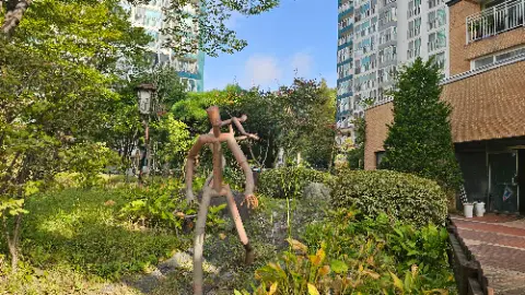 A wooden statue of a man with a bird on