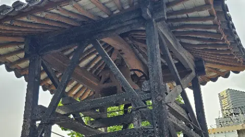 A wooden structure with a large wheel on top