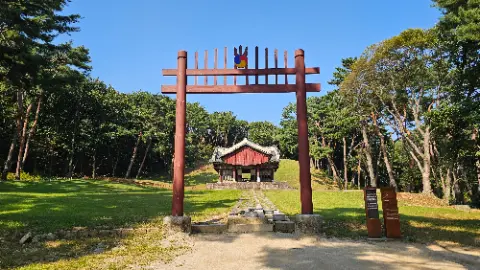 A wooden structure with a red roof and a blue