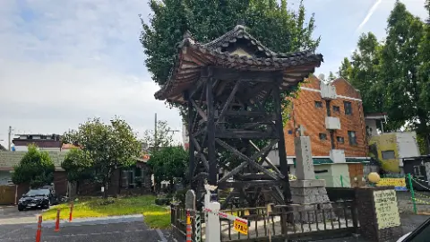 A wooden structure with a roof and a cross on