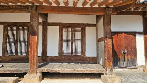 A wooden structure with a window and a door