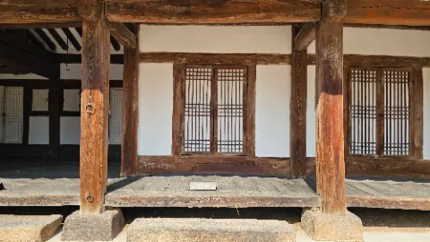 A wooden structure with a window and a door