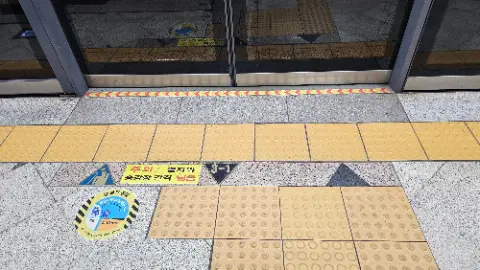 A yellow and black tile floor with a sign that